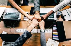 People in group making a group fist bump